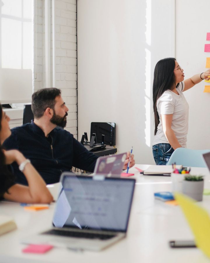 A team planning a release around a table, mapping the work on the wall